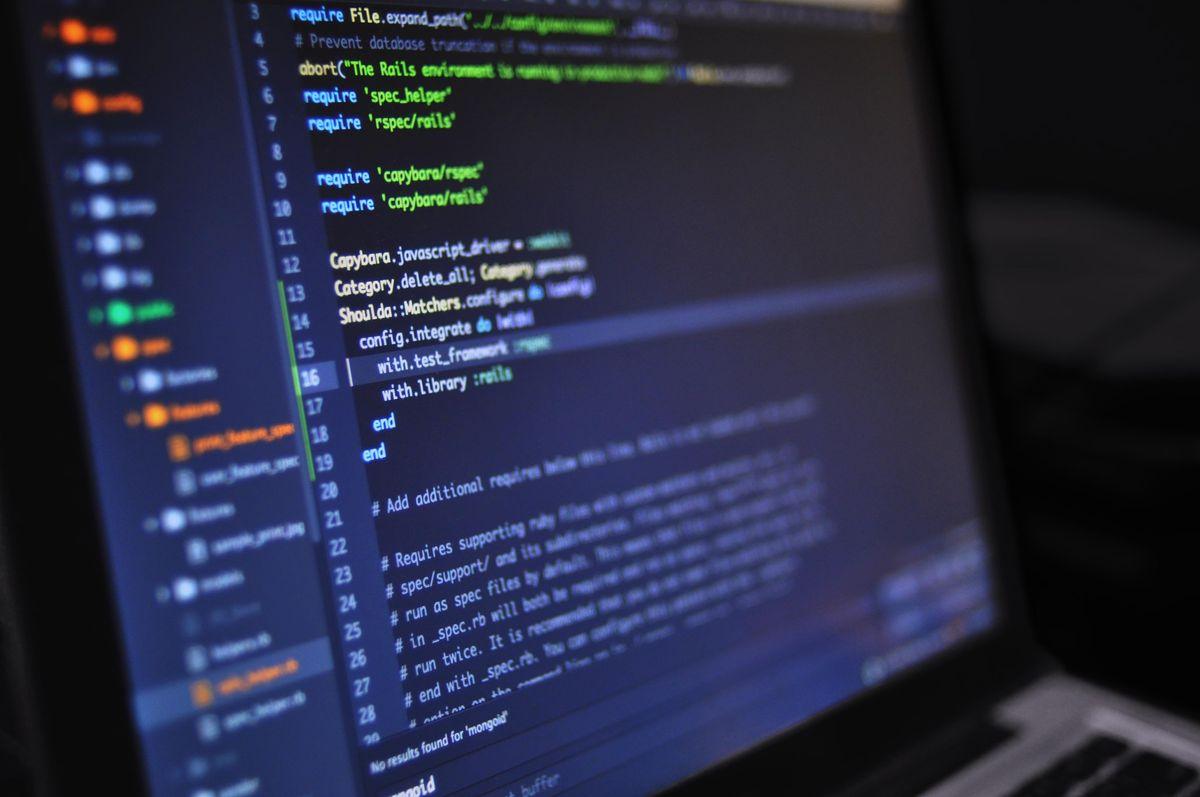 Developer writing code on a laptop
